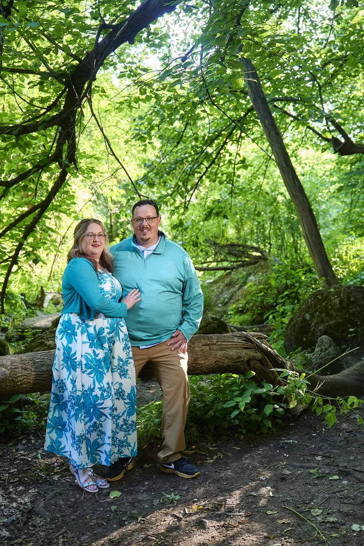 Kimberly and Stephen standing along a wooded trail