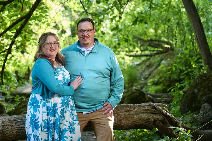 Kimberly and Stephen smiling together in the woods